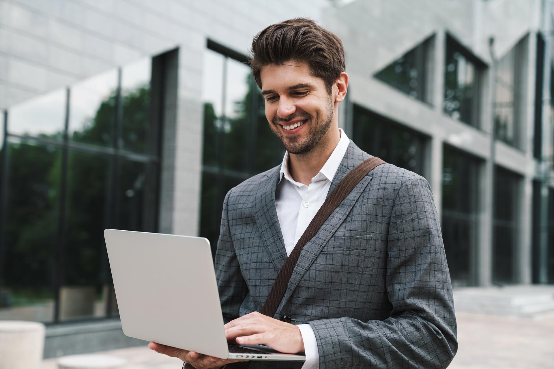 optimistic-handsome-business-man-using-laptop-2021-08-29-02-45-20-utc.jpg